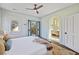 Light-filled bedroom with balcony access and arched doorway leading to a stylish bathroom at 34 Percy St, Charleston, SC 29403