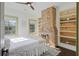 Bedroom featuring exposed brick fireplace and ample natural light at 34 Percy St, Charleston, SC 29403