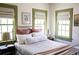 Bedroom showcasing a decorative bed and multiple windows for natural light at 34 Percy St, Charleston, SC 29403