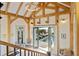Upstairs landing with exposed beams looks out over the pool area through open doors at 34 Percy St, Charleston, SC 29403