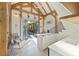 Bright open kitchen with island and view of the outdoor pool area through open doors at 34 Percy St, Charleston, SC 29403