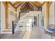 Open-concept living and kitchen space with modern island and seating beneath a staircase at 34 Percy St, Charleston, SC 29403