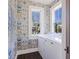 Laundry room with front load washer and dryer and decorative wallpaper at 34 Percy St, Charleston, SC 29403