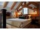 Comfortable bedroom featuring exposed beams, a plush bed, and stylish lighting fixtures at 34 Percy St, Charleston, SC 29403