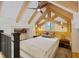 A lofted bedroom featuring exposed beam ceiling with a comfortable bed and rustic decor at 34 Percy St, Charleston, SC 29403