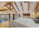 Cozy bedroom with high ceilings and wooden beams, overlooking a pool view from the loft at 34 Percy St, Charleston, SC 29403