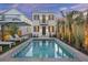 Stunning pool and backyard with palm trees at twilight at 34 Percy St, Charleston, SC 29403