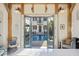 Open doors leading to a beautiful pool and backyard, framed by light wood beams, creating an inviting indoor-outdoor flow at 34 Percy St, Charleston, SC 29403
