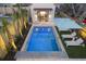 Charming backyard pool and pool house, featuring a pristine pool, lounge chairs, and a cozy outdoor space at 34 Percy St, Charleston, SC 29403