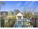 Balcony view of a backyard pool, lounge chairs, and a charming pool house, perfect for outdoor living at 34 Percy St, Charleston, SC 29403