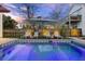 Relaxing backyard pool area featuring an umbrella, lounge chairs and manicured lawn at 34 Percy St, Charleston, SC 29403