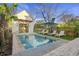 Inviting backyard pool with lounge chairs and a charming pool house provides a private oasis at 34 Percy St, Charleston, SC 29403