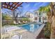 Inviting backyard featuring a refreshing pool with lounge chairs, a pergola, and well-maintained landscaping for ultimate relaxation at 34 Percy St, Charleston, SC 29403