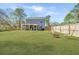 Large backyard features a fire pit, outdoor seating, a screened in porch, and a new wooden fence at 3405 Painswick Rd, Johns Island, SC 29455