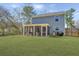 Spacious backyard featuring a screened-in porch, lush green lawn, and a surrounding of mature trees at 3405 Painswick Rd, Johns Island, SC 29455