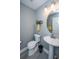 Comfortable half-bathroom with a pedestal sink, round mirror, and tiled floors at 3405 Painswick Rd, Johns Island, SC 29455