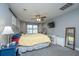 Relaxing bedroom with a comfortable queen bed, ceiling fan, TV, and ample natural light at 3405 Painswick Rd, Johns Island, SC 29455