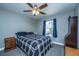 Comfortable bedroom with a ceiling fan, a plaid comforter, and natural light from the window at 3405 Painswick Rd, Johns Island, SC 29455