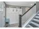 Inviting entryway featuring coat rack, wooden staircase, and natural lighting, perfect for welcoming guests at 3405 Painswick Rd, Johns Island, SC 29455