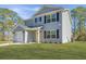 Two-story home showcasing a light blue exterior, black shutters, green lawn, and an attached one-car garage at 3405 Painswick Rd, Johns Island, SC 29455