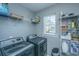 Functional laundry room with modern washer and dryer, shelving and ample storage space at 3405 Painswick Rd, Johns Island, SC 29455