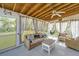 Relaxing sunroom with vaulted wood ceiling, neutral furniture, ceiling fan, and sheer curtains at 3405 Painswick Rd, Johns Island, SC 29455
