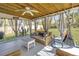 Bright sunroom featuring comfortable seating, a ceiling fan, stylish decor, and a serene view of the backyard at 3405 Painswick Rd, Johns Island, SC 29455