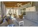 Inviting sunroom with a cozy sofa, wicker chairs, ceiling fan, and abundant natural light at 3405 Painswick Rd, Johns Island, SC 29455