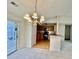 Dining space features a chandelier and pass through to the kitchen with black appliances at 344 Eagle Ridge Rd, Summerville, SC 29485