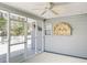 The screened-in porch features an artful display, ceiling fan and opens to the back yard at 344 Eagle Ridge Rd, Summerville, SC 29485