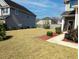 Spacious back yard with recently mowed lawn and mature landscaping along property borders at 3614 Haymont Ln, Ladson, SC 29456