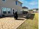 Stone patio area in backyard featuring seating and a covered grill at 3614 Haymont Ln, Ladson, SC 29456