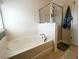 Bright bathroom features a separate tub and glass-enclosed shower in a neutral palette at 3614 Haymont Ln, Ladson, SC 29456