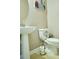 This half bathroom features a pedestal sink and a matching toilet at 3614 Haymont Ln, Ladson, SC 29456