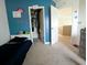 Bedroom with blue accent wall, toys, and adjoining room view at 3614 Haymont Ln, Ladson, SC 29456
