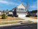 Charming two-story home featuring a two-car garage, landscaped yard, and classic architectural details at 3614 Haymont Ln, Ladson, SC 29456