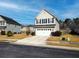 Charming two-story home featuring a two-car garage, landscaped yard, and classic architectural details at 3614 Haymont Ln, Ladson, SC 29456