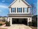 Two-story home featuring a spacious garage with black shutters and neutral colored siding at 3614 Haymont Ln, Ladson, SC 29456