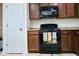 Charming kitchen with black appliances, wood cabinets, and tile flooring at 3614 Haymont Ln, Ladson, SC 29456