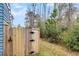Wooden gate leading to a wooded area, adding privacy and charm to the property at 3726 Apiary Ln, Johns Island, SC 29455
