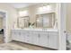 Bright bathroom features a double vanity with white cabinets, gold hardware, and dual mirrors at 3726 Apiary Ln, Johns Island, SC 29455