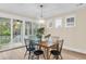 Elegant dining area with modern chandelier and sliding doors to an outdoor porch at 3726 Apiary Ln, Johns Island, SC 29455