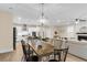 Cozy dining area with stylish chandelier, adjacent to a bright modern kitchen and living room at 3726 Apiary Ln, Johns Island, SC 29455