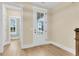 Bright entryway with hardwood floors and a white door that leads to the front porch, offering a warm welcome at 3726 Apiary Ln, Johns Island, SC 29455