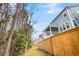 View of the house from wooded area, showing the back elevation and screened porch at 3726 Apiary Ln, Johns Island, SC 29455