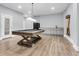 Spacious game room featuring a stylish pool table, modern lighting, and a convenient wet bar area at 3726 Apiary Ln, Johns Island, SC 29455