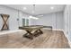 Bright game room with a pool table, modern lighting, and wood laminate flooring for easy maintenance at 3726 Apiary Ln, Johns Island, SC 29455