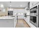 Modern kitchen with white cabinets, stainless steel appliances, and an island with a sink at 3726 Apiary Ln, Johns Island, SC 29455