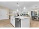 Bright open kitchen with white cabinets and island with a dishwasher and eat-in bar at 3726 Apiary Ln, Johns Island, SC 29455