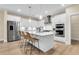 Bright, white kitchen with stainless steel appliances and a kitchen island with bar stool seating at 3726 Apiary Ln, Johns Island, SC 29455